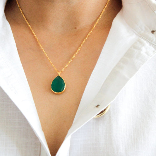Women in a white shirt wearing a gorgeous green onyx necklace in 18k gold vermeil